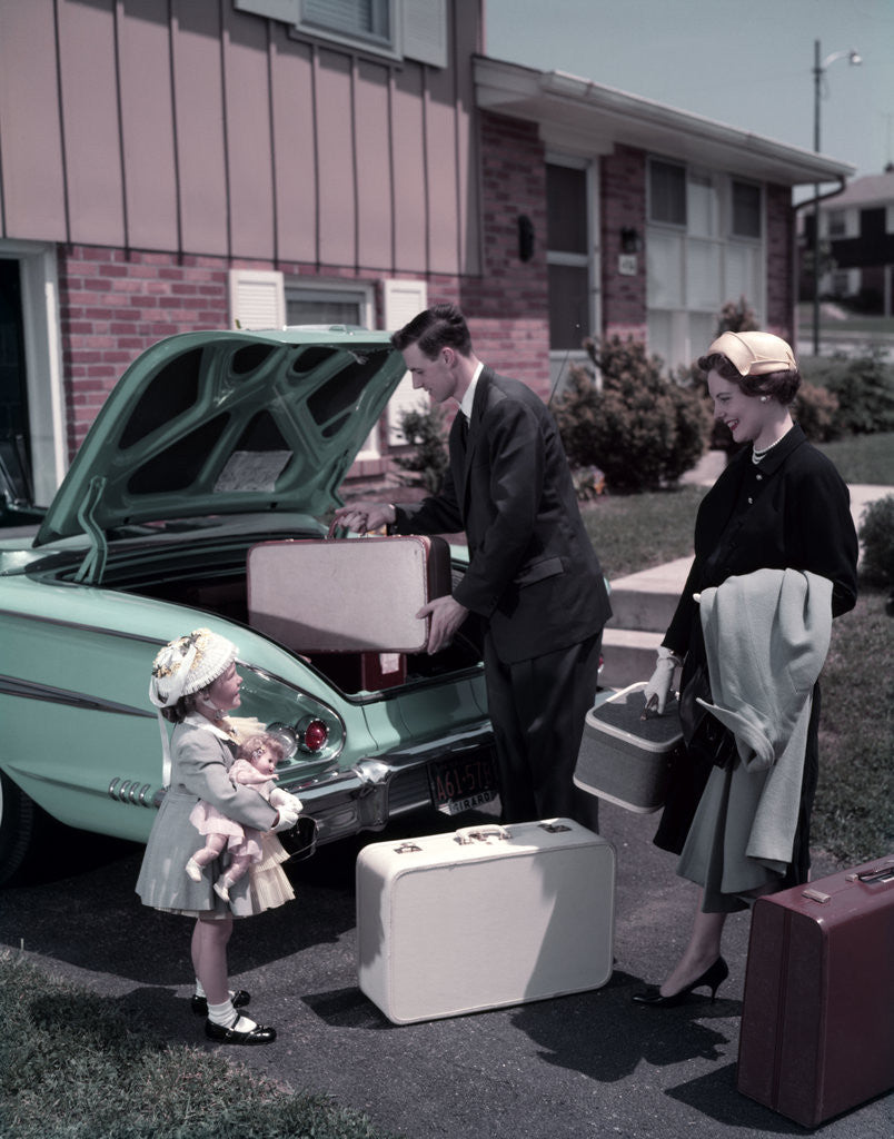 Detail of 1950s Family Mother Father Daughter In Front Of Suburban House Packing Luggage In Car For Vacation by Anonymous