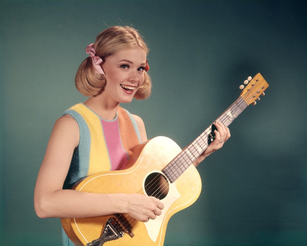 Detail of 1960s Perky Young Teenager Folk Singer Playing Guitar by Anonymous