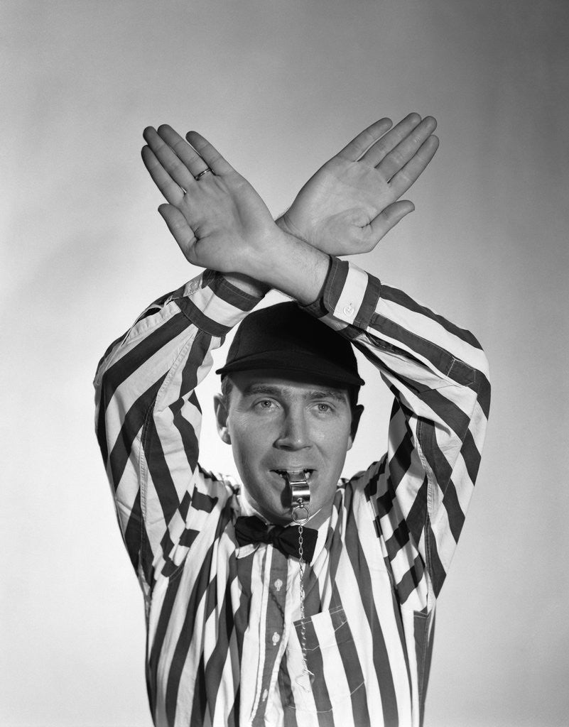 Detail of 1950s Football Referee Making Hand Signal Time Out Blowing Whistle by Corbis