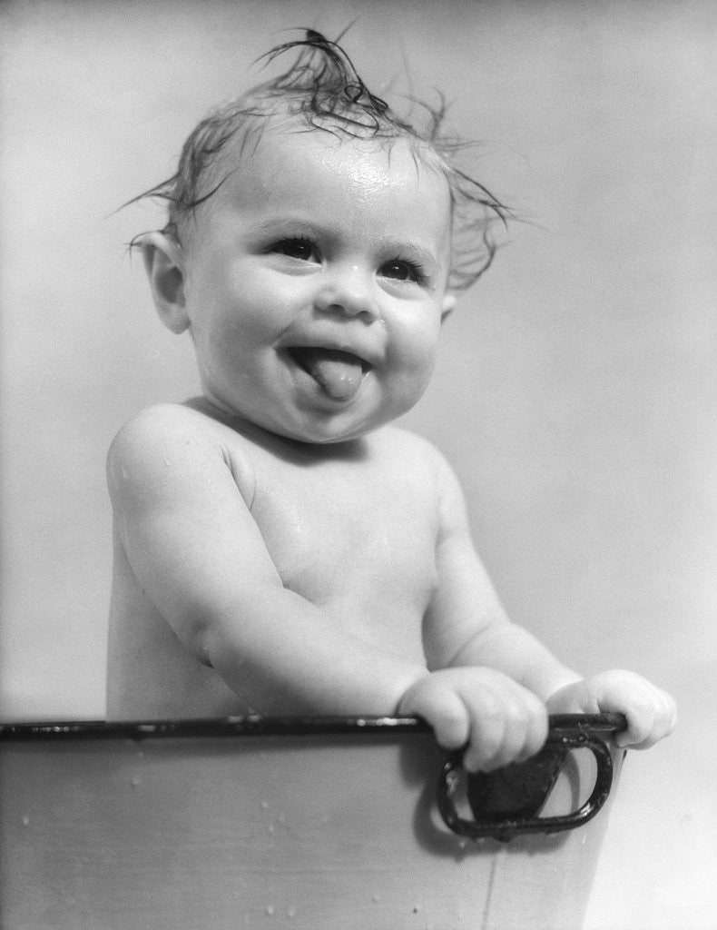 Detail of 1940s 1930s Wet Baby Sitting In Tub Sticking Out Tongue by Anonymous