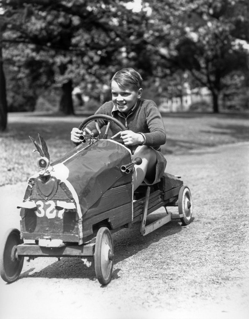 Detail of 1930s Boy Driving Home Built Race Car Holding Steering Wheel by Anonymous