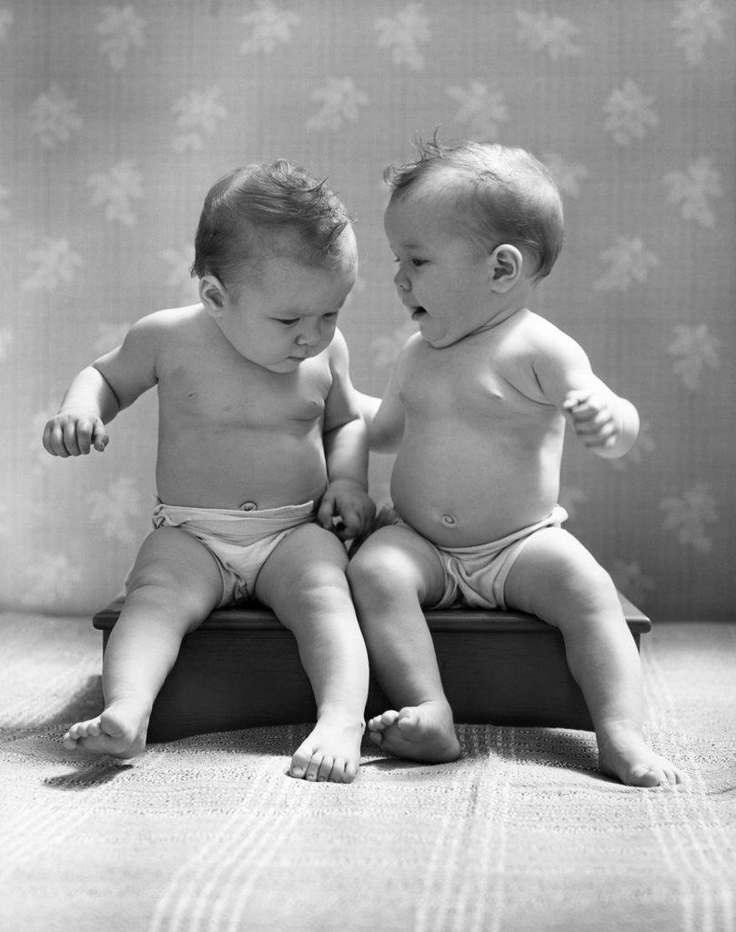 Detail of 1930s 1940s Twin Babies Wearing Diapers Together Sitting On A Bench Side By Side Studio by Anonymous