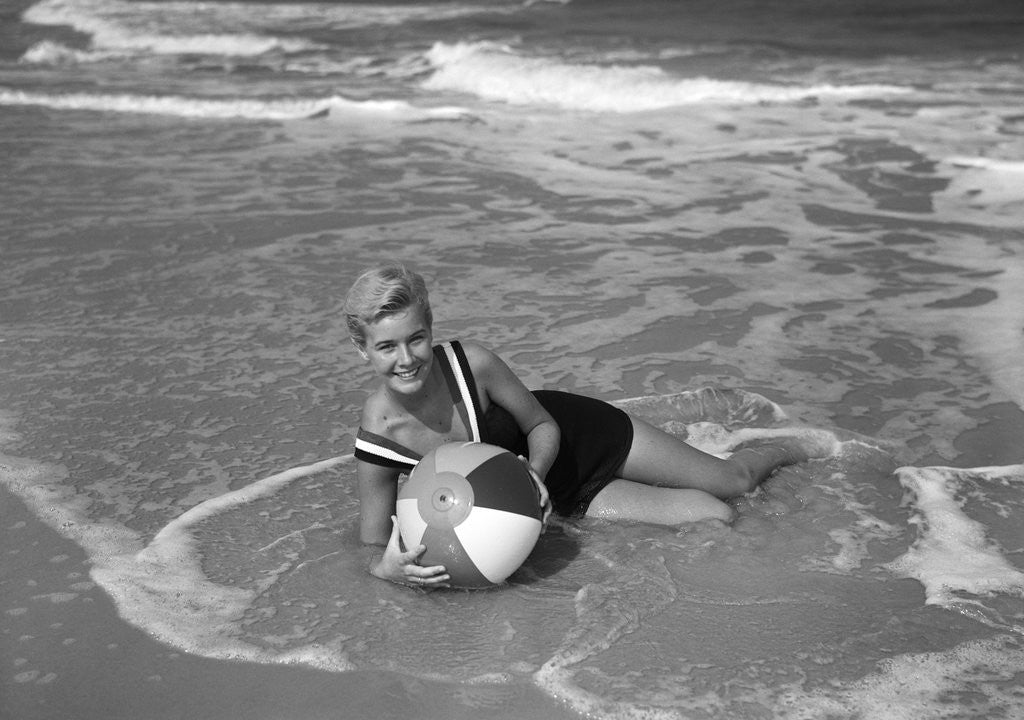 Detail of 1960s Woman In Bathing Suit Lying In The Surf Holding A Beach Ball Outdoor by Anonymous