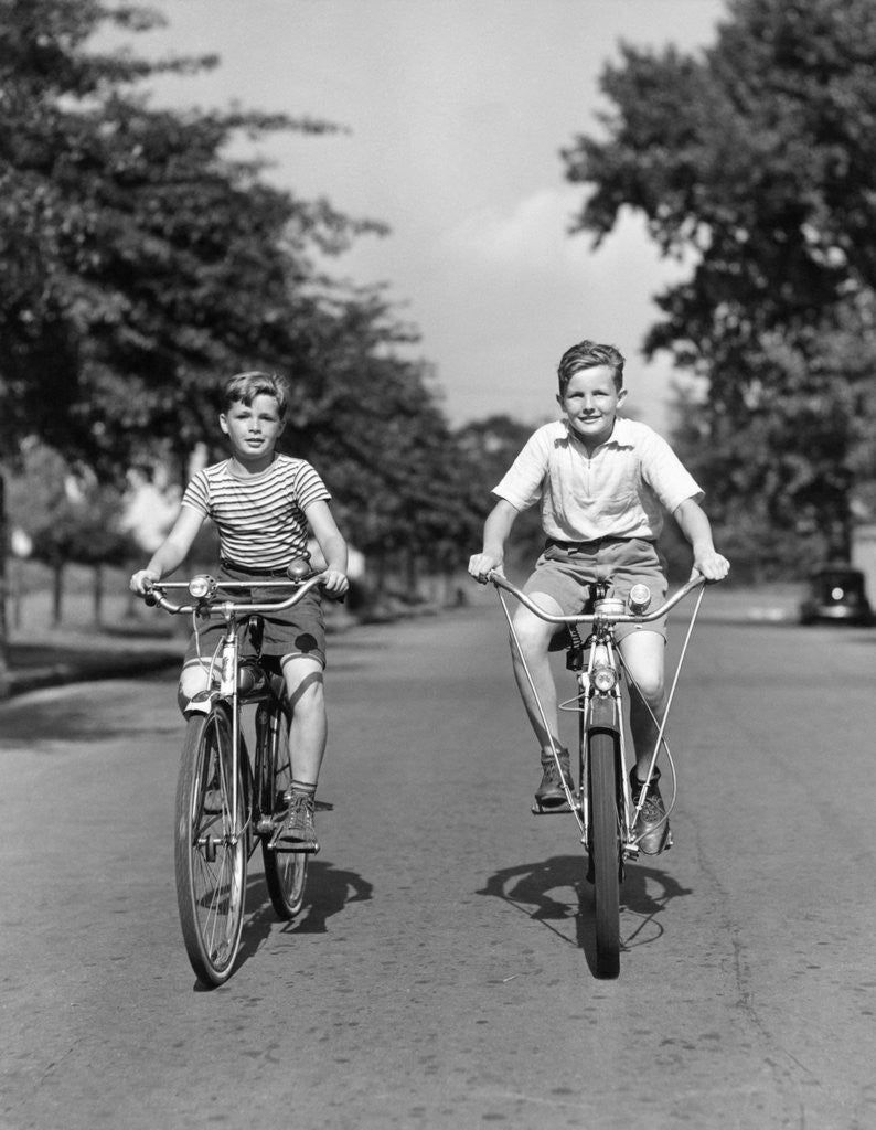 Detail of 1930s 1940s Two Boys Riding Bikes On Tree Lined Street by Anonymous