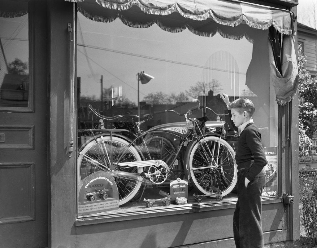 Detail of 1950s Boy On Sidewalk Looking At Bicycle In Store Window by Corbis