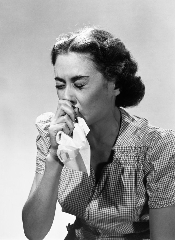 Detail of 1950s Woman Eyes Closed With Cold Sneezing Into Handkerchief by Corbis