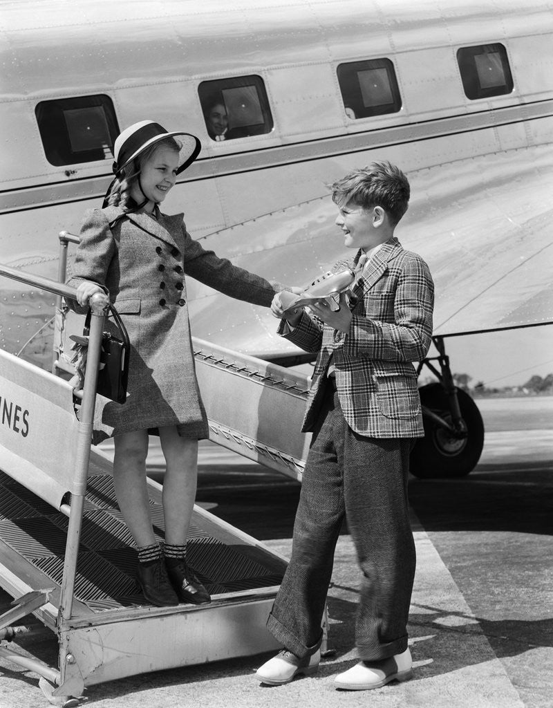 Detail of 1940s Boy Girl Walking Off Boarding Ramp Of Airplane Boy Holds Toy Plane Dress Fashion Suit Tie by Corbis