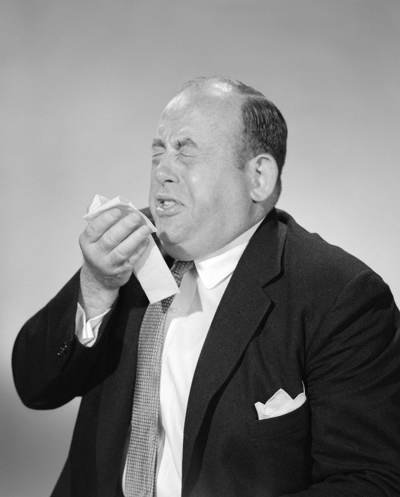 Detail of 1950s 1960s Bald Man Sneezing Handkerchief To Nose by Corbis