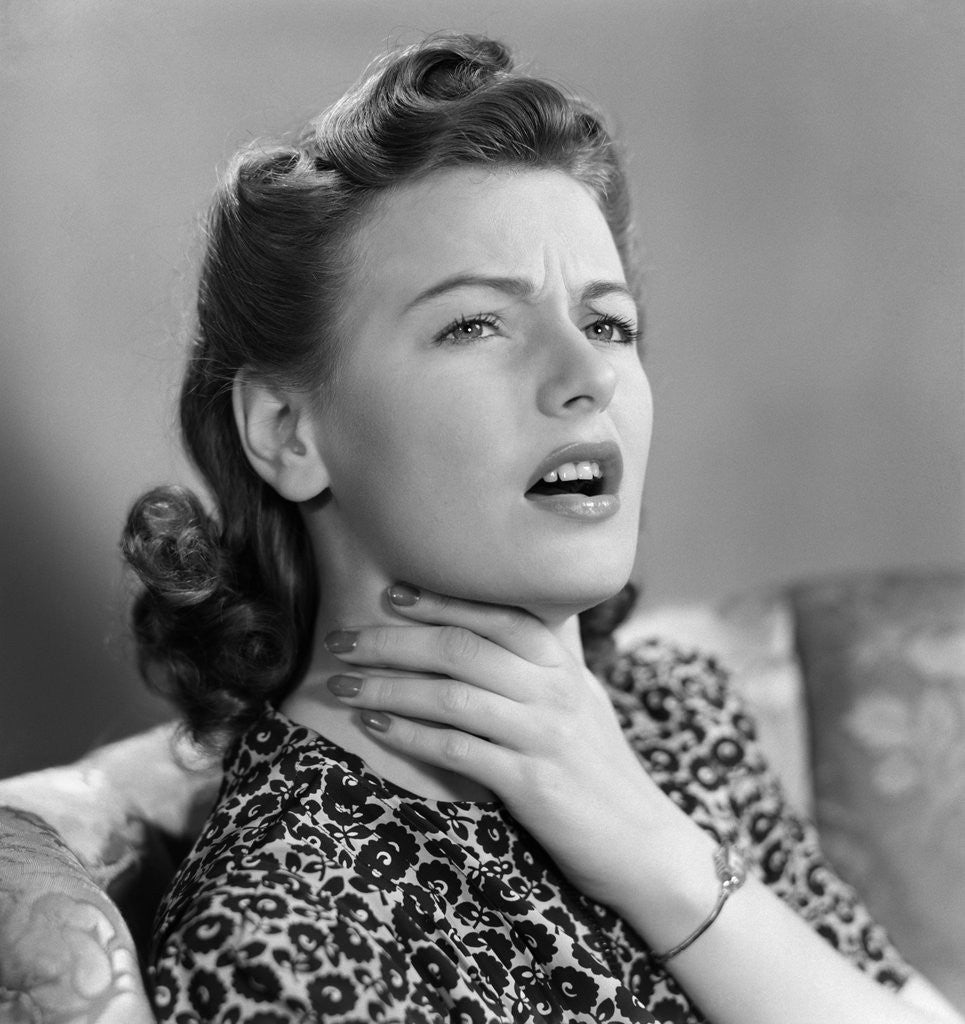 Detail of 1940s Portrait Of Woman Holding Her Sore Throat With Expression Of Discomfort And Pain by Anonymous