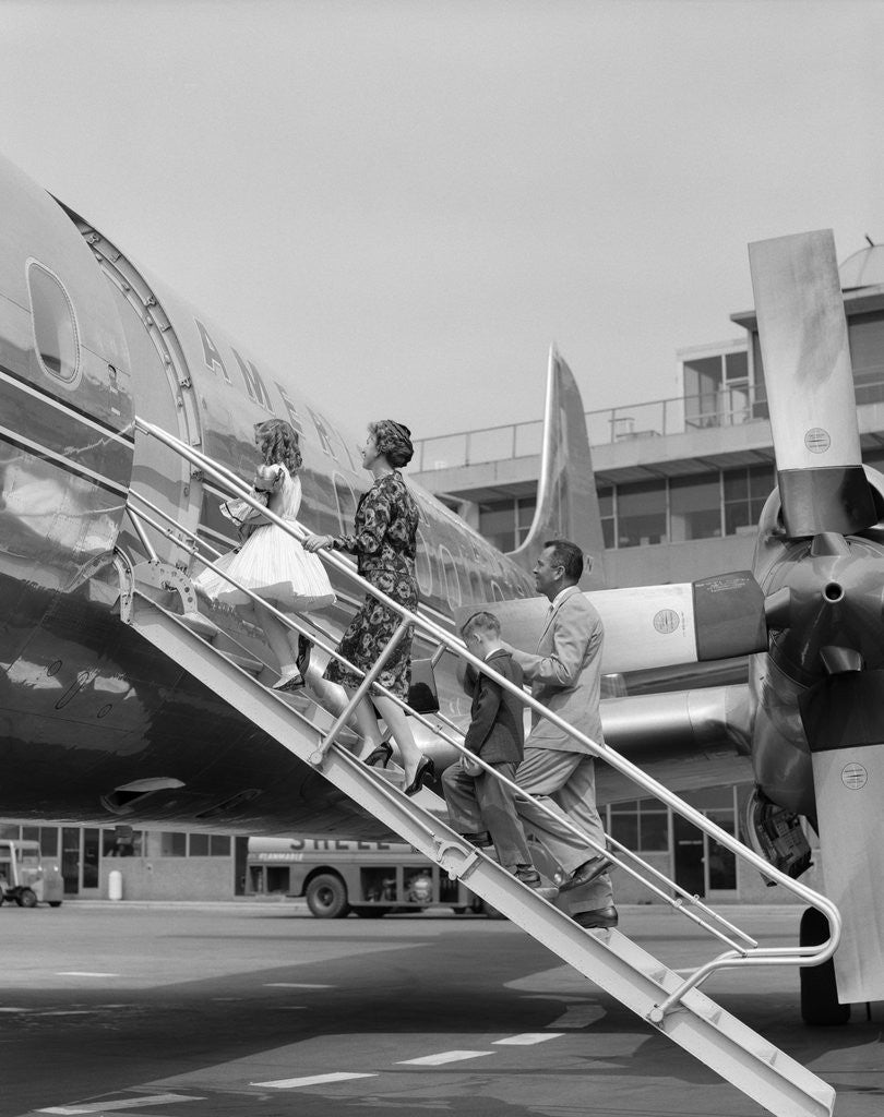 Detail of 1950s Family Boarding Propeller Airliner By Climbing Gangway Stairs At Airport by Anonymous