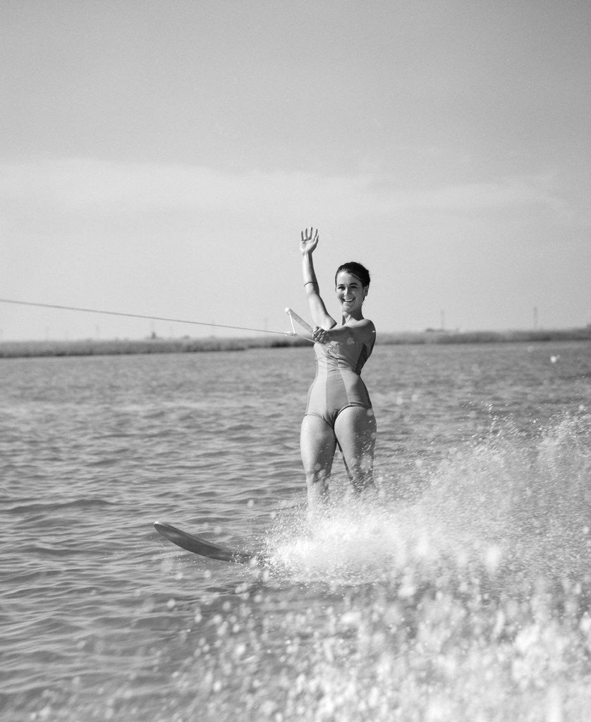 Detail of 1960s Woman Water Skiing Waving With One Hand by Corbis