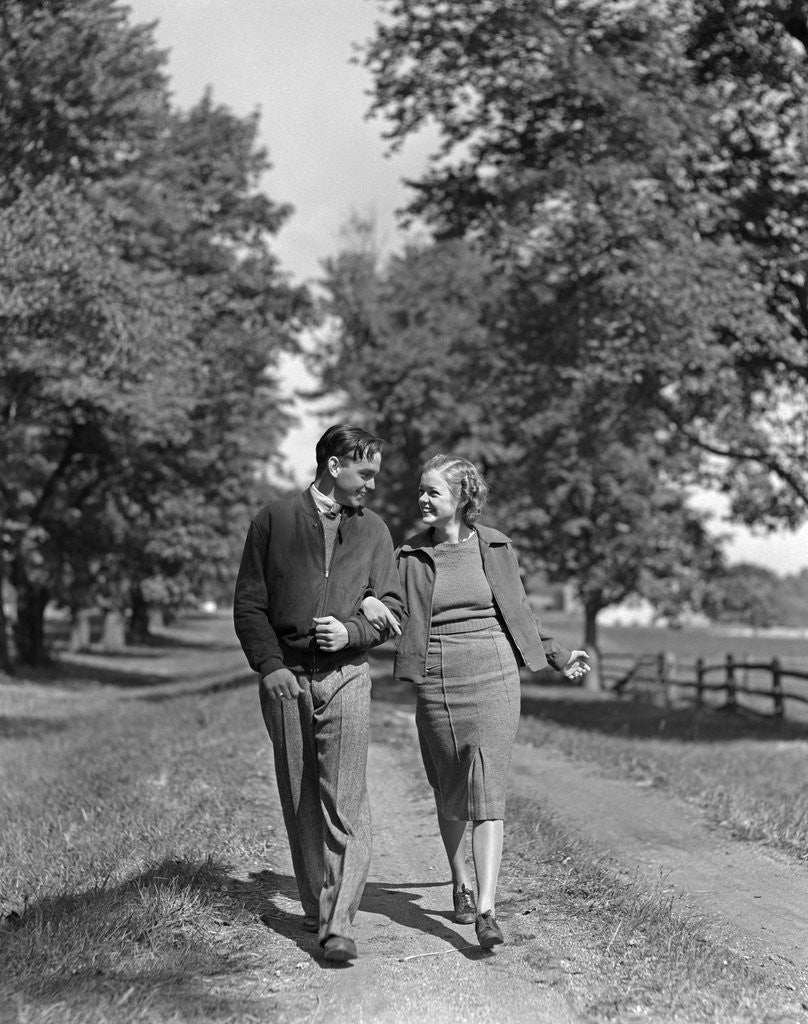 Detail of 1930s 1940s Young Teen Couple Boy Girl Strolling Down Autumn Country Lane Arm In Arm by Anonymous
