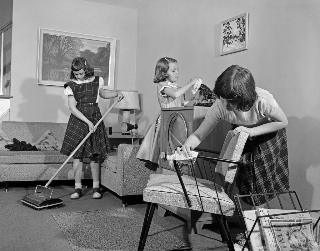 Detail of 1950s Three Pre-Teen Young Girls Cleaning Living Room Dusting Vacuuming by Anonymous