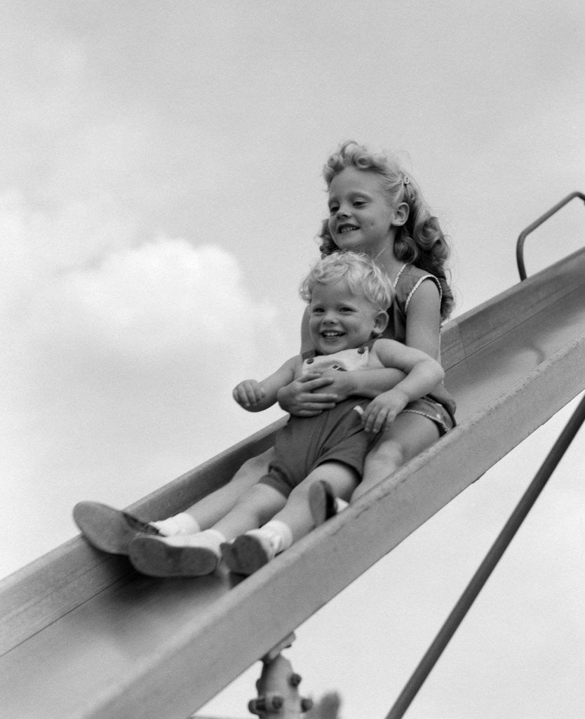 Detail of 1950s 1960s Two Children Going Down Playground Slide by Anonymous