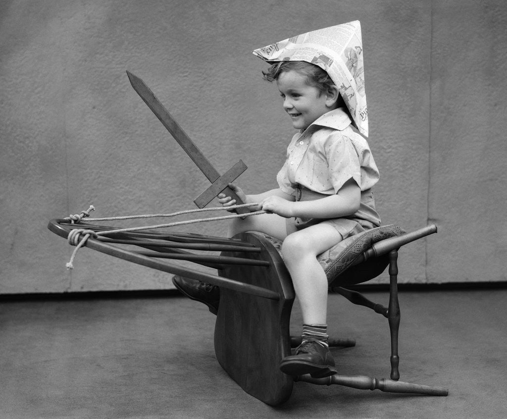 Detail of 1930s Boy Playing Wooden Sword Paper Hat Riding Chair Like A Horse by Anonymous