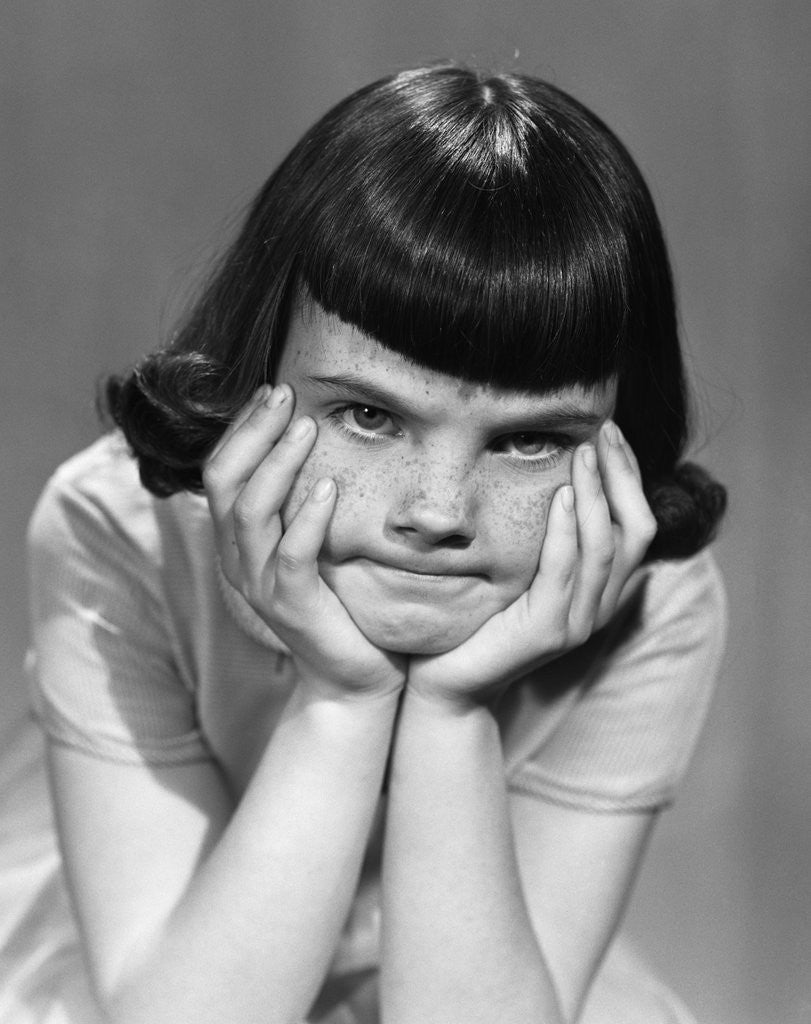 Detail of 1950s Mad Angry Frustrated Girl Head Resting In Hands by Corbis