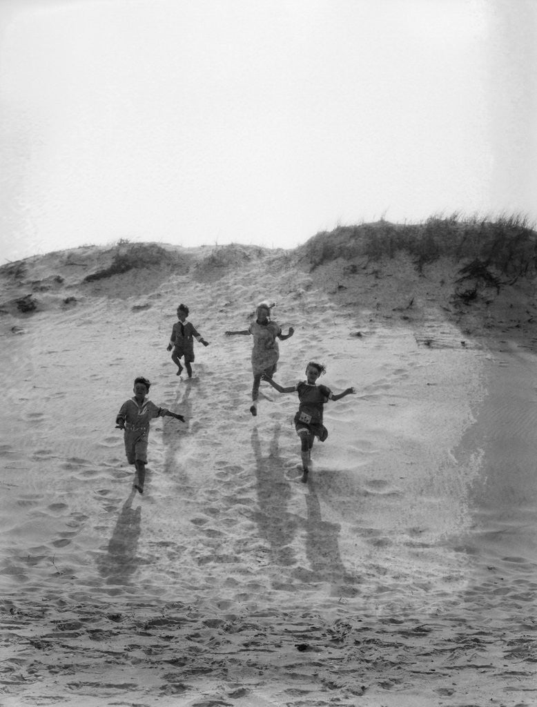 Detail of 1920s 4 Kids 2 Boys 2 Girls Running Down Sand Dune by Corbis
