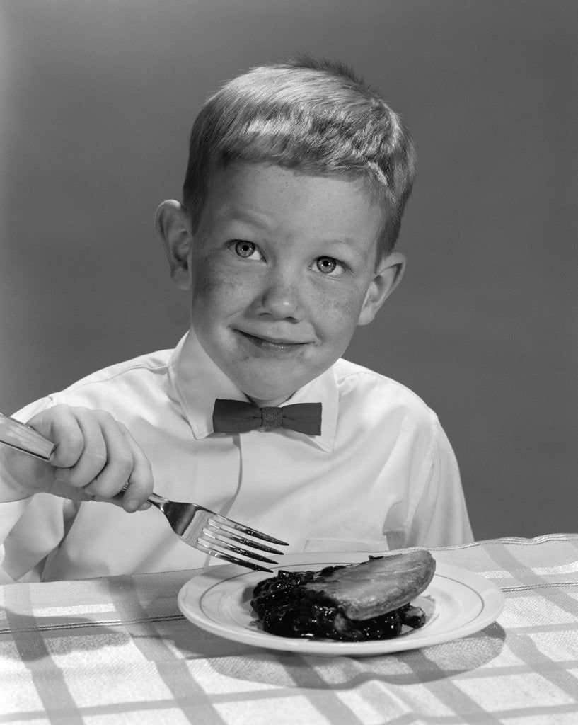 Detail of 1960s Boy Wearing Bow Tie Eating Pie Dessert With Fork by Anonymous