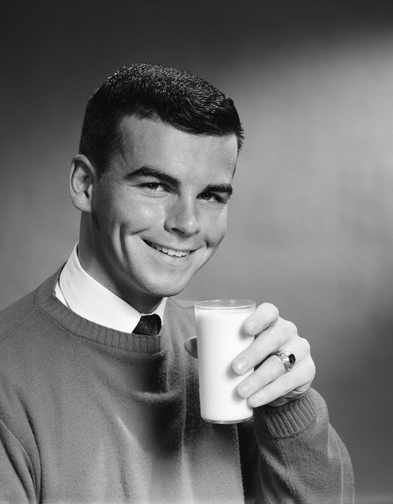 Detail of 1960s Young Man Holding Glass Of Milk by Corbis