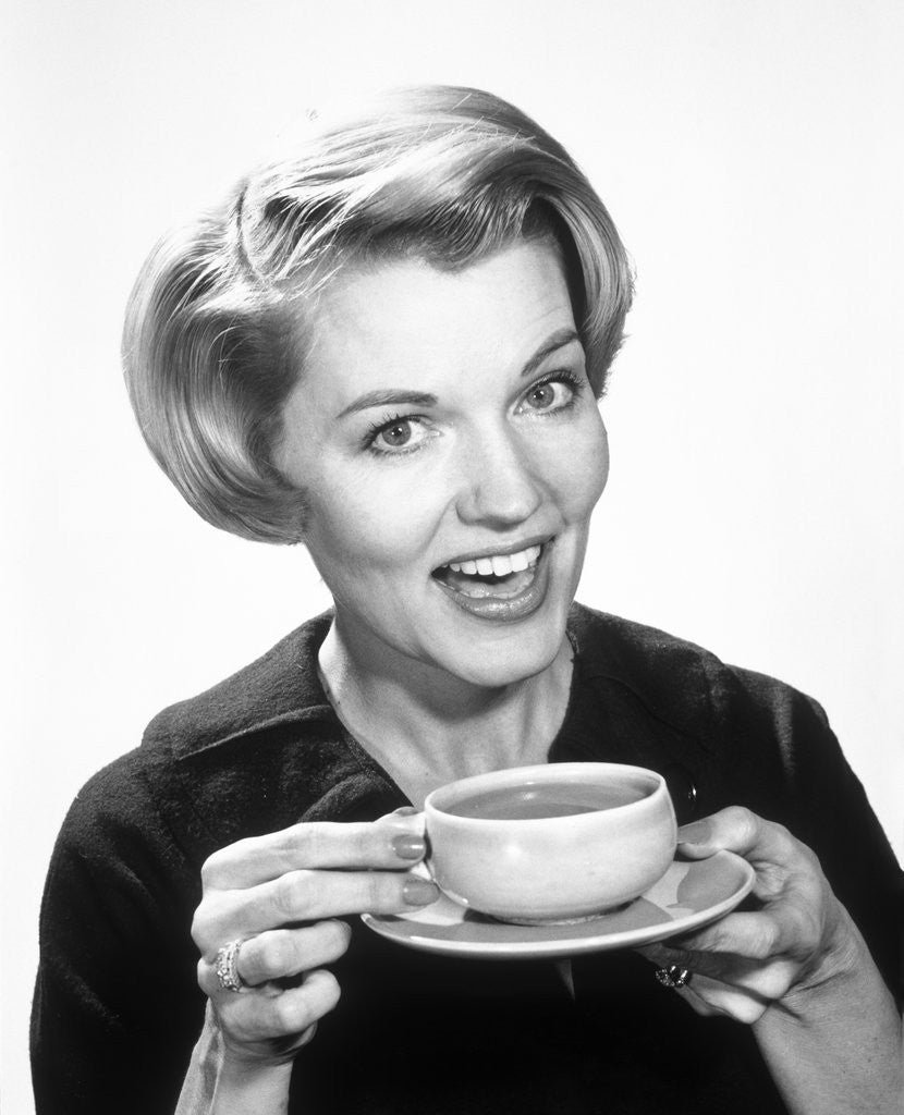 Detail of 1960s Woman Drinking Coffee Holding Cup And Saucer by Anonymous
