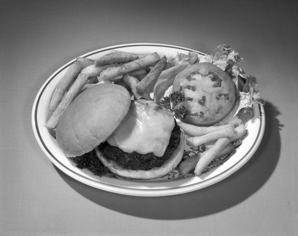 Detail of 1950s 1960s Cheeseburger Deluxe On Plate French Fries Lettuce by Corbis