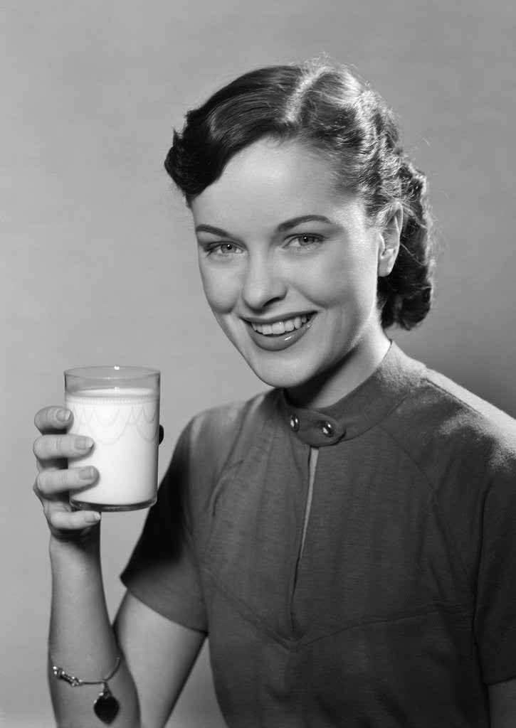Detail of 1950s Portrait Woman Holding A Glass Of Milk Studio by Anonymous