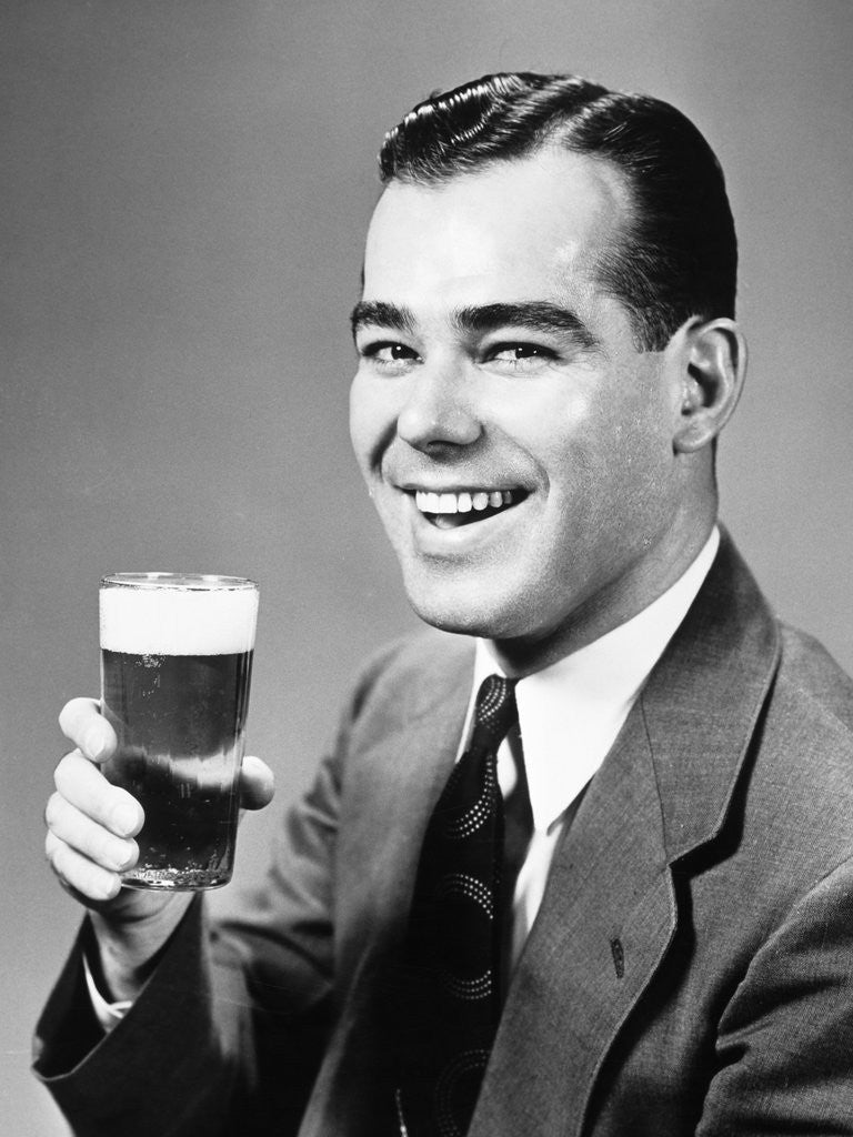 Detail of 1940s Man Holding Glass Of Beer by Corbis
