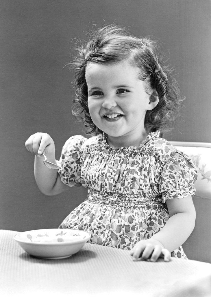 Detail of 1940s 1930s Little Girl Eating Bowl Of Ice Cream by Corbis