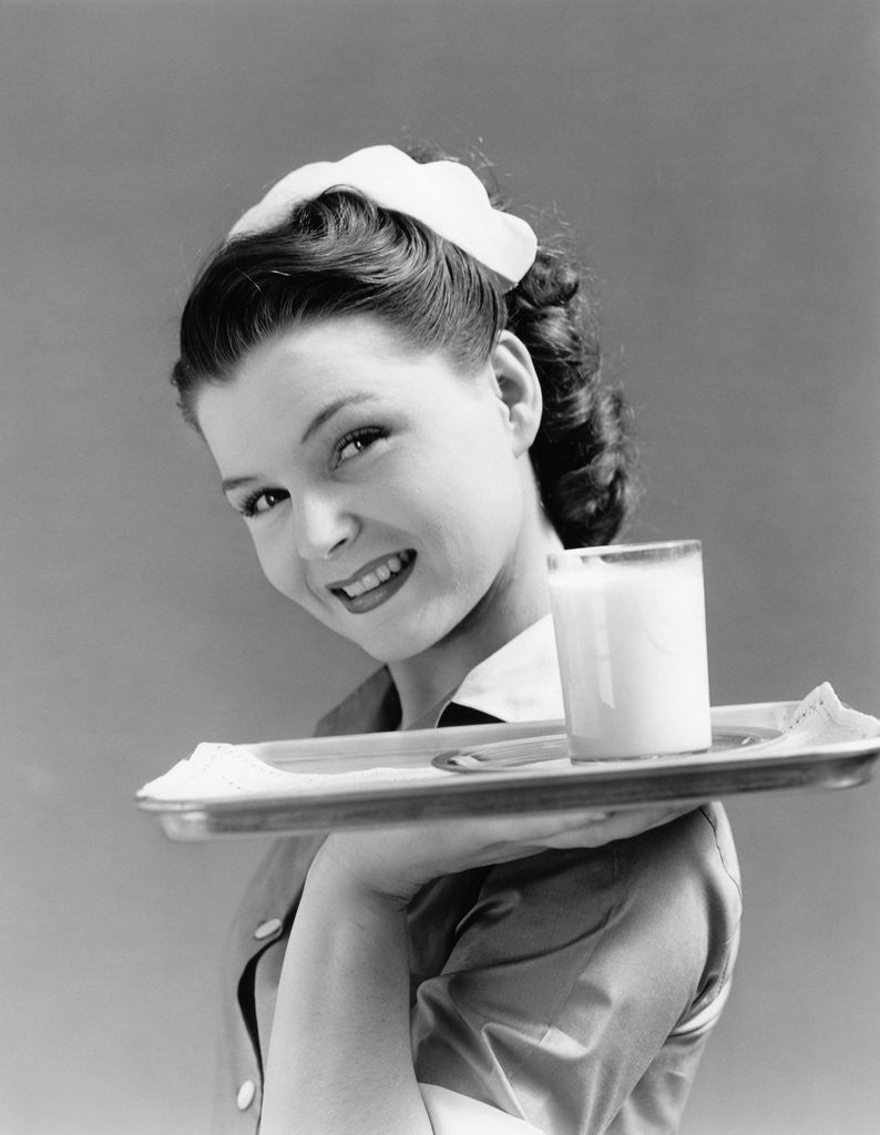 Detail of 1940s Waitress Carrying Glass Of Milk On Tray by Anonymous