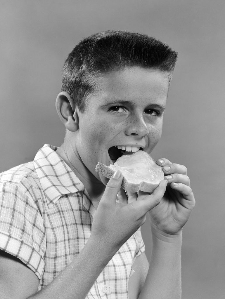 Detail of 1950s Boy With Crew Cut Eating A Slice Of Bread by Anonymous