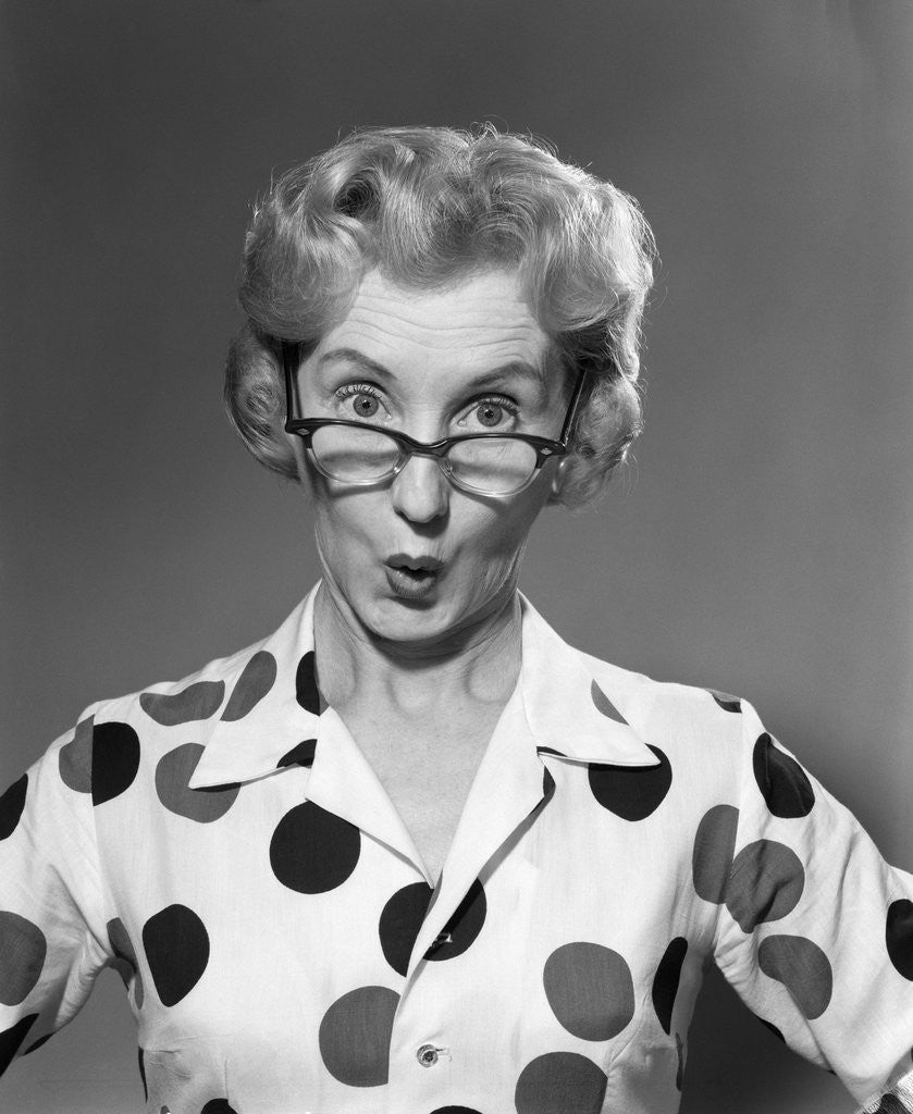 Detail of 1950s 1960s Portrait Woman Polka Dot Dress Looking Over Eyeglasses by Anonymous