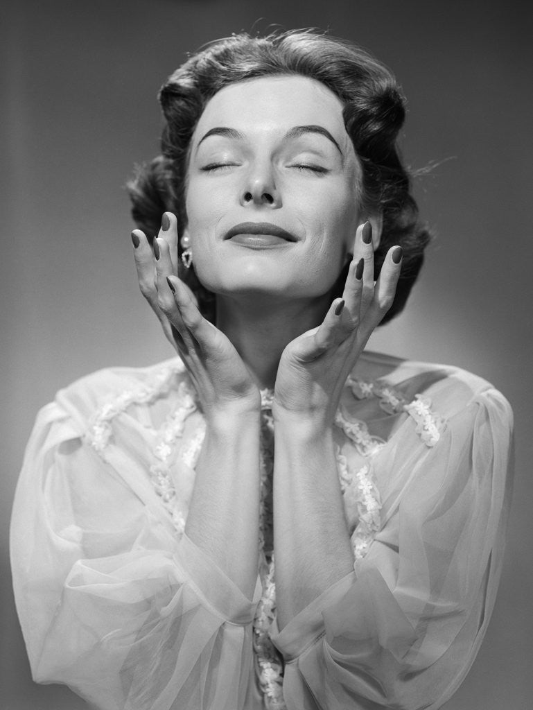Detail of 1950s Woman Wearing Peignoir With Eyes Closed Hands Held Near Face Ecstatic Facial Expression by Anonymous