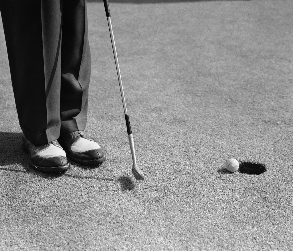 Detail of 1950s Man Knees Down Putt On Golf Green by Anonymous
