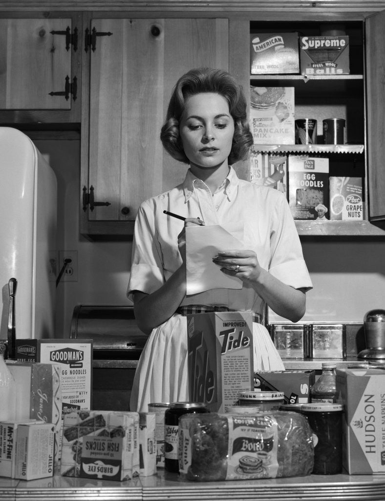 Detail of 1960s Woman Housewife In Kitchen Checking Grocery Food Shopping List by Anonymous
