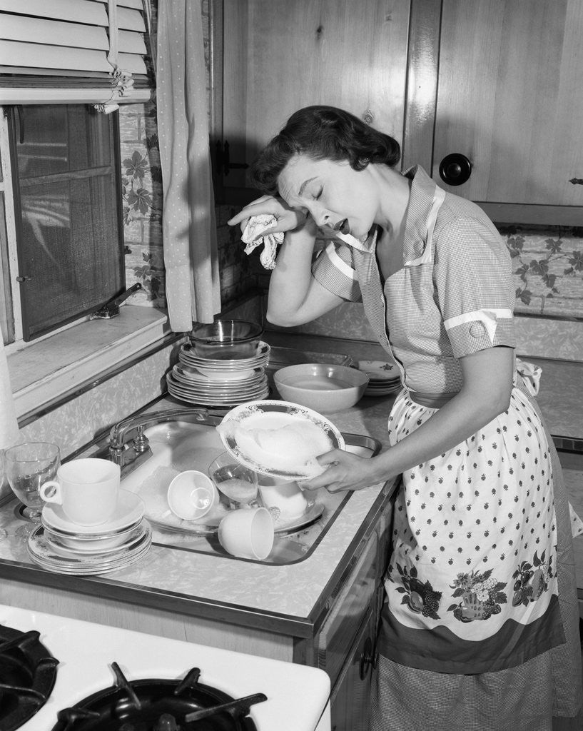 Detail of 1950s Tired Exhausted Woman Housewife In Kitchen With Sink Full Of Dirty Dishes by Anonymous