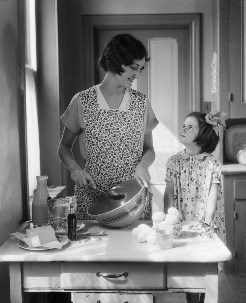 Detail of 1920s 1930s Mother With Mixing Bowl In Kitchen With Daughter by Anonymous