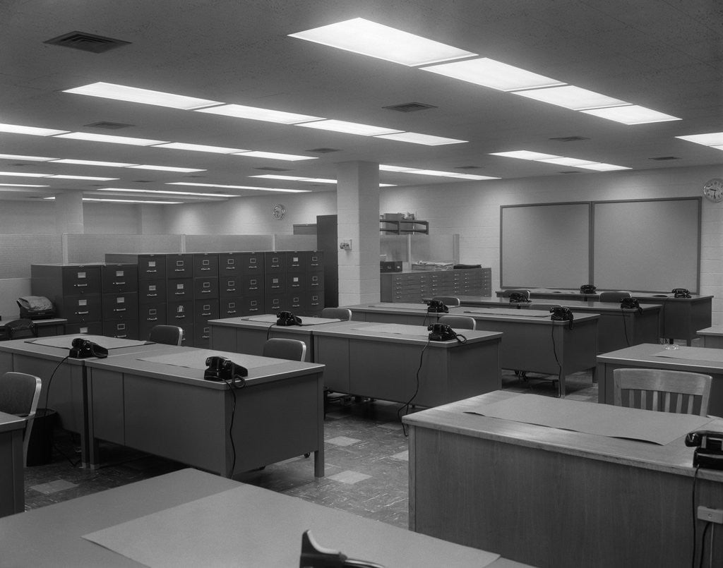Detail of 1950s 1960s Office With Desks Black Phones And File Cabinets by Anonymous