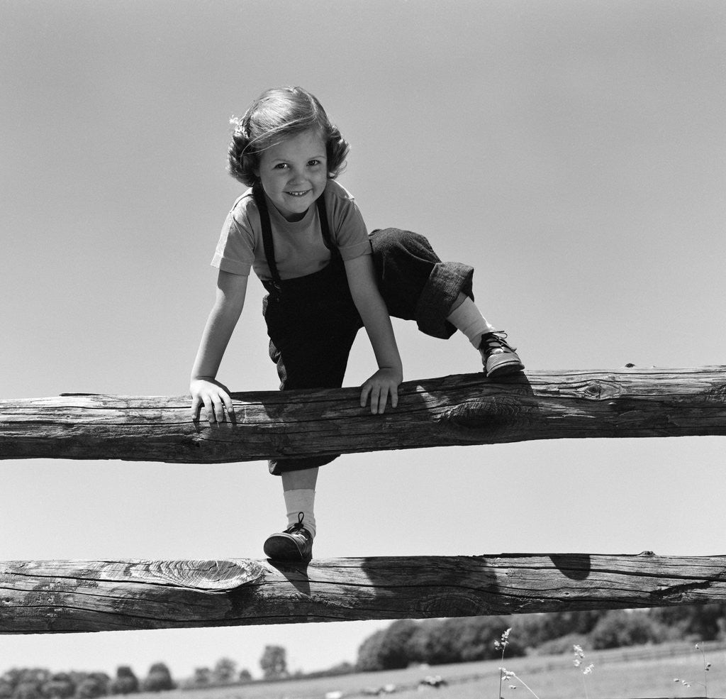 Detail of 1940s 1950s Girl Climbing Over Wooden Fence by Anonymous