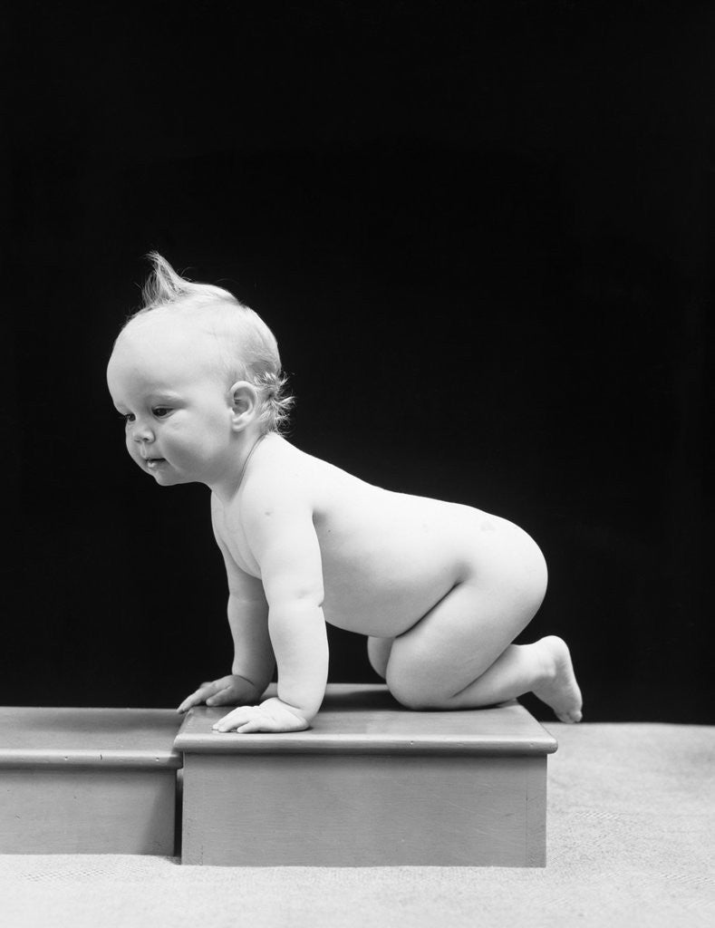 Detail of 1930s 1940s Naked Baby Crawling On Wooden Box by Corbis
