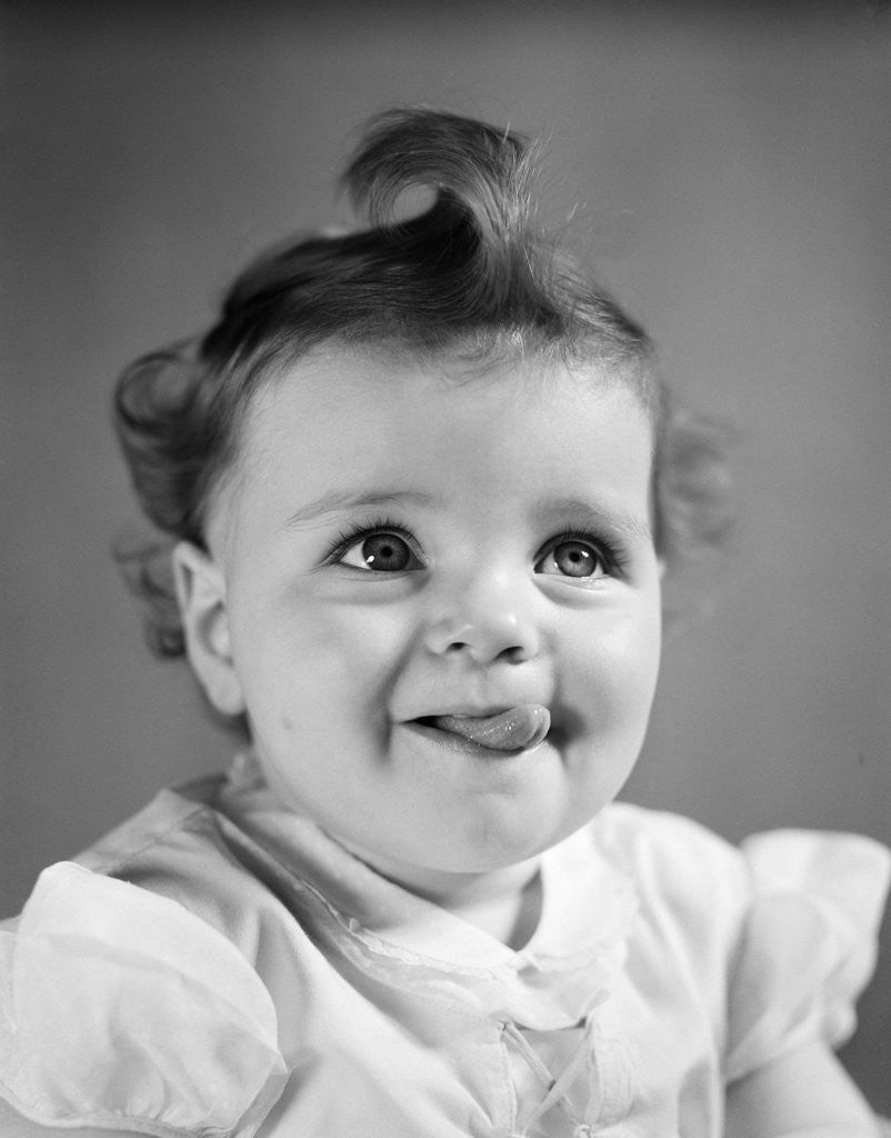 Detail of 1940s Baby Girl Sticking Out Her Tongue by Anonymous