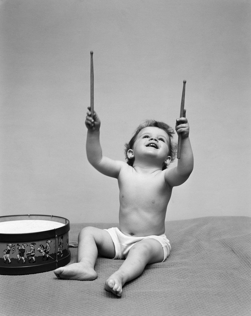 Detail of 1940s Baby In Diaper With Drum Holding Up Drumsticks by Anonymous