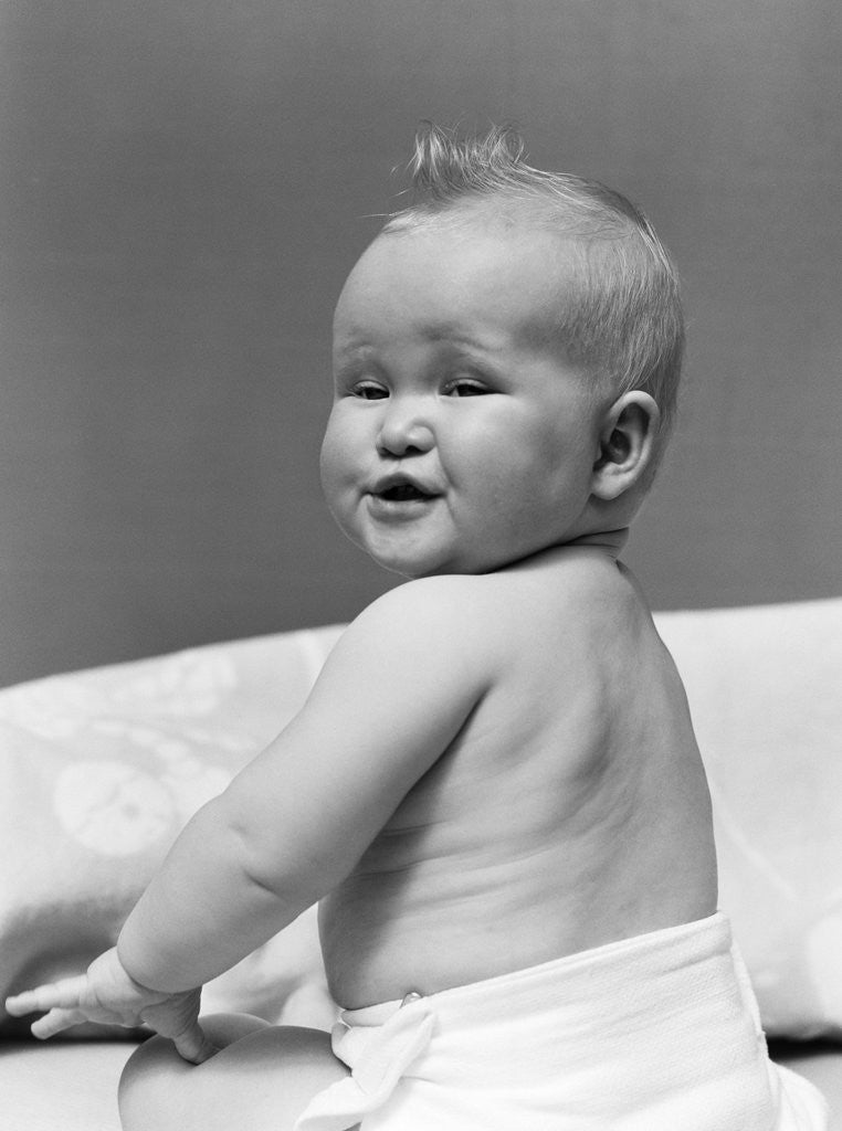 Detail of 1940s Baby In Diaper Looking Back Over Shoulder With Funny Facial Expression by Anonymous
