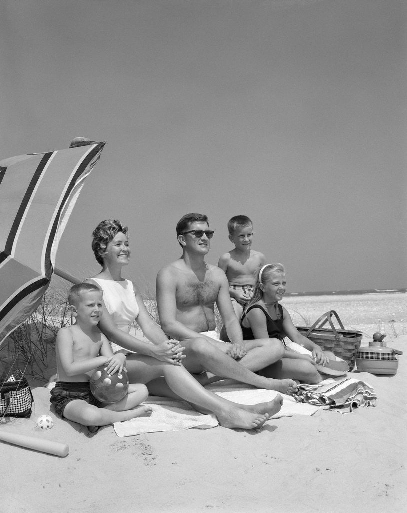 Detail of 1960s Family Portrait Mother Father Daughter And Two Sons Sitting On Beach Under Umbrella by Anonymous