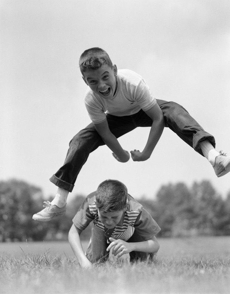 Detail of 1960s Retro Boys Playing Leap Frog Outside Sky Grass Jump Jumping Crouching by Anonymous
