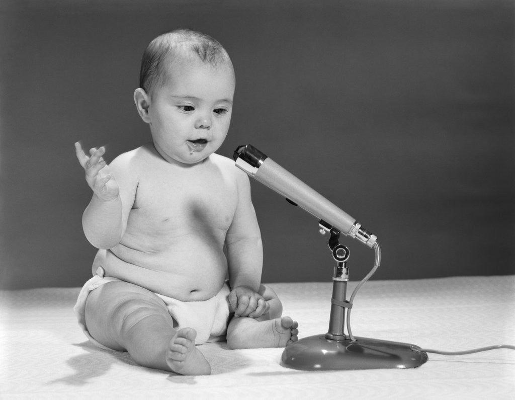 Detail of 1960s Baby In Diaper Speaking Into Microphone by Anonymous