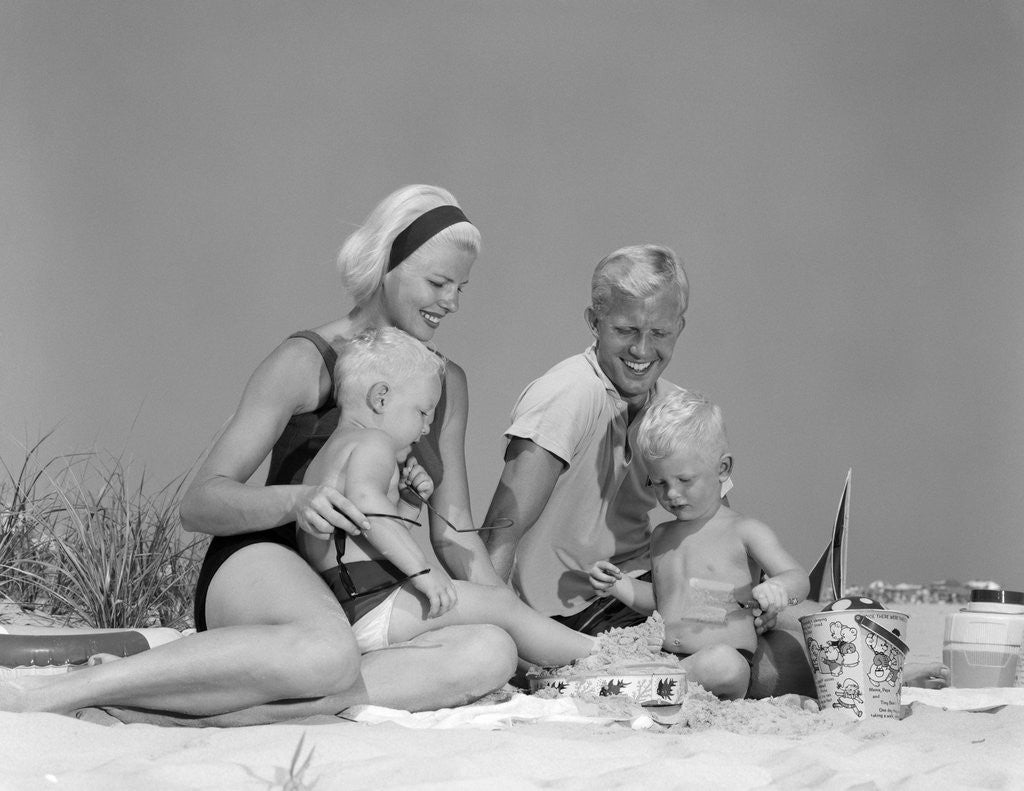 Detail of 1970s 1960s Family Father Mother Twin Sons Playing In Sand On Beach Outdoor by Anonymous