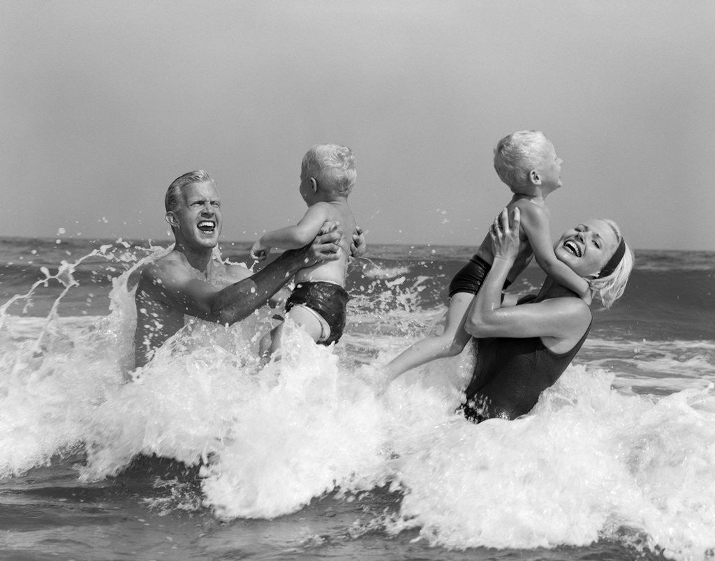 Detail of 1970s 1960s Family Father Mother Holding Up A Twin Sons In The Ocean Surf by Anonymous