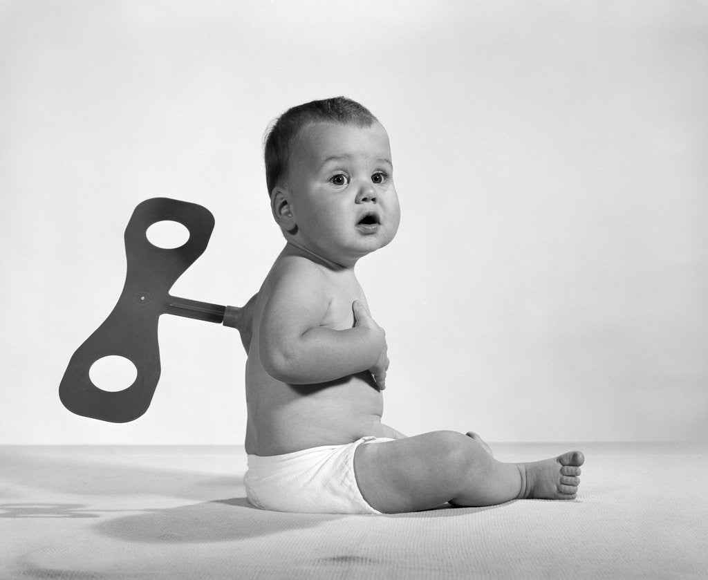 Detail of 1960s 1970s Seated Baby In Diaper With Windup Key In His Back by Corbis