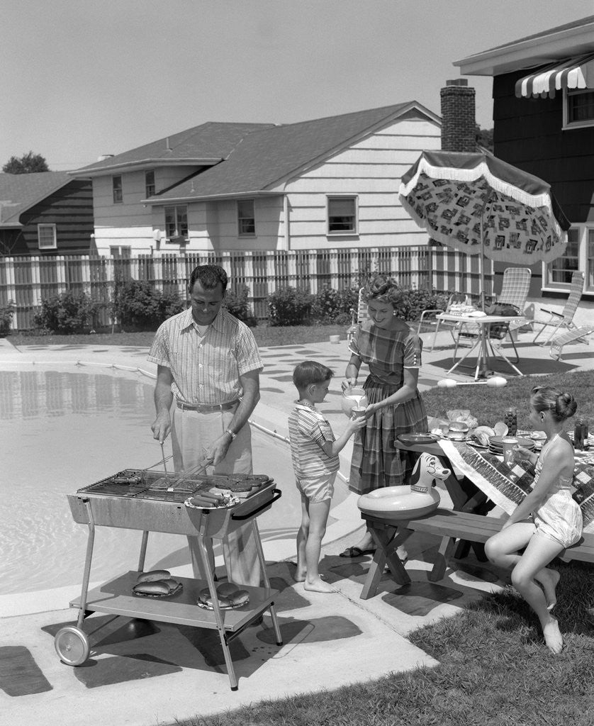 Detail of 1950s Family In Backyard Beside Pool Having Cookout Of Hot Dogs and Hamburgers by Anonymous