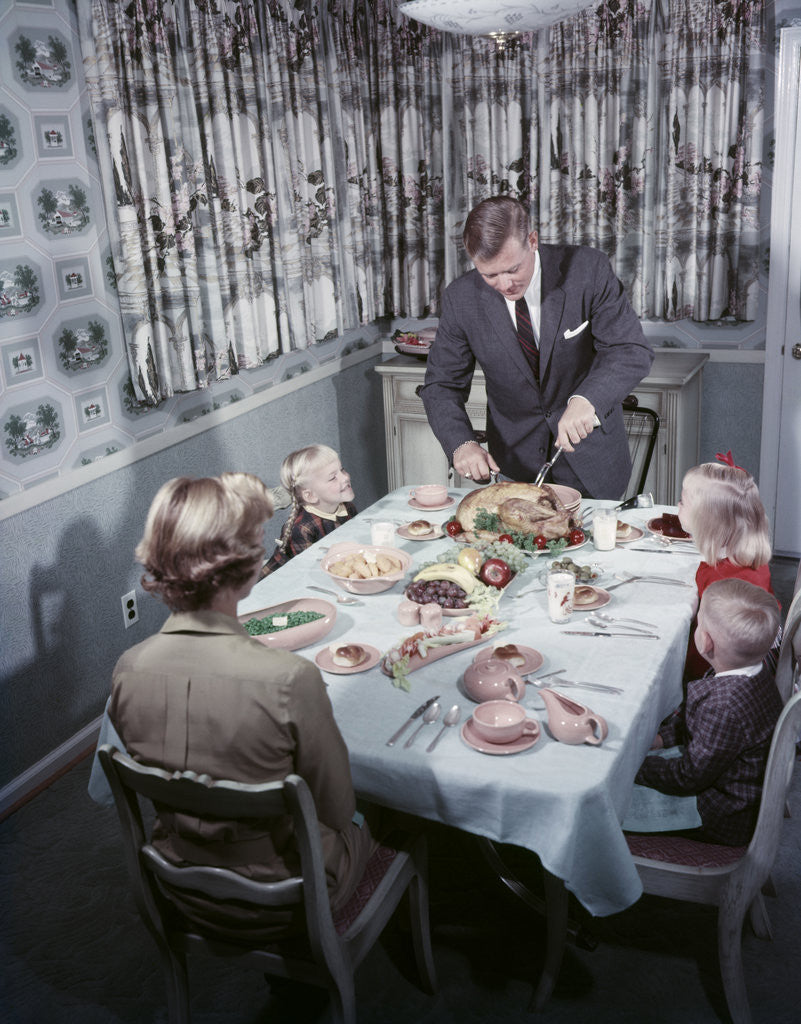 Detail of 1950s Family 5 Sitting At Dining Room Table Dad Carves Turkey At Head Of Table by Anonymous